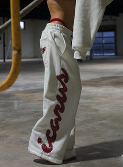 Pantalon de jogging rouge à clous motif crocodile