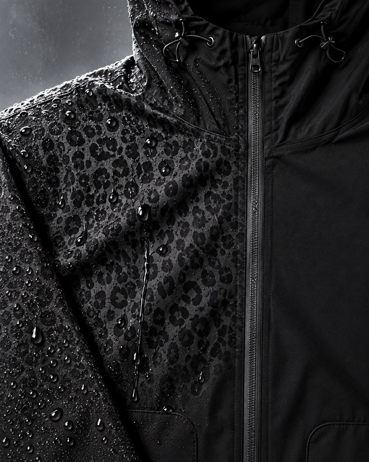 Macro detail of water droplets revealing the tonal cheetah pattern beside dry matte fabric